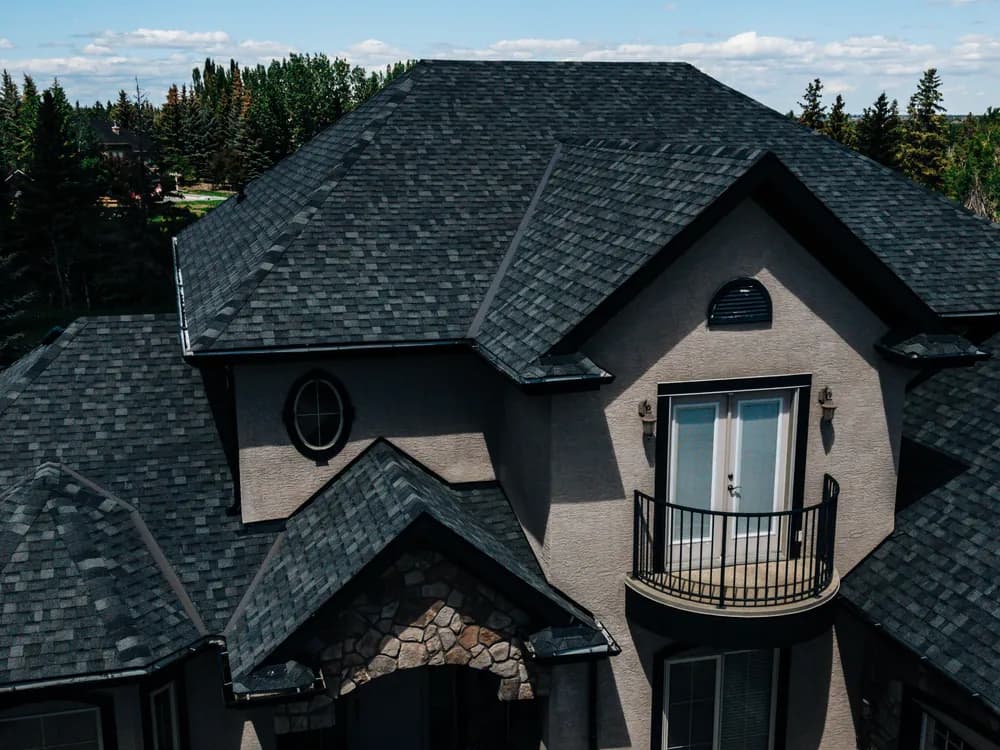 Aerial view of a completed asphalt shingle roof on a Calgary home