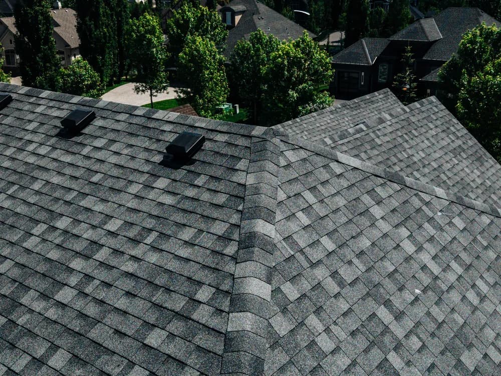 Close up of newly installed charcoal asphalt shingles on a Calgary roof