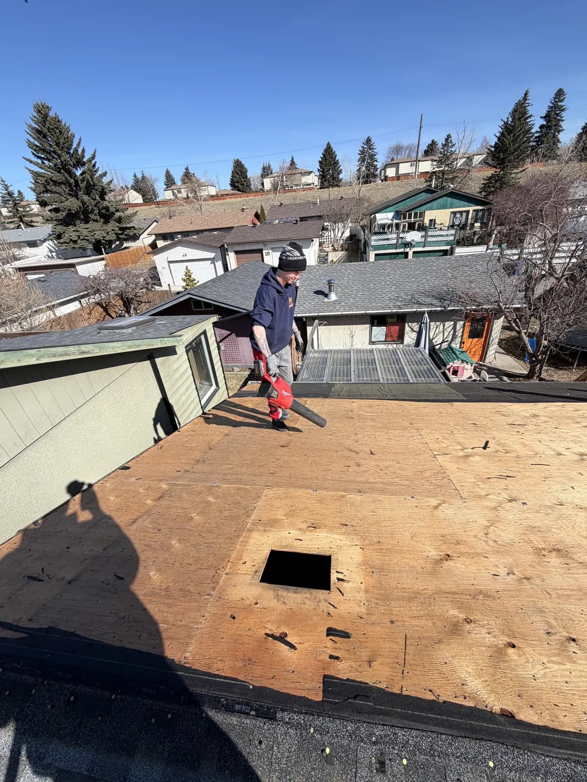 Bare plywood roof deck after the old shingles were removed