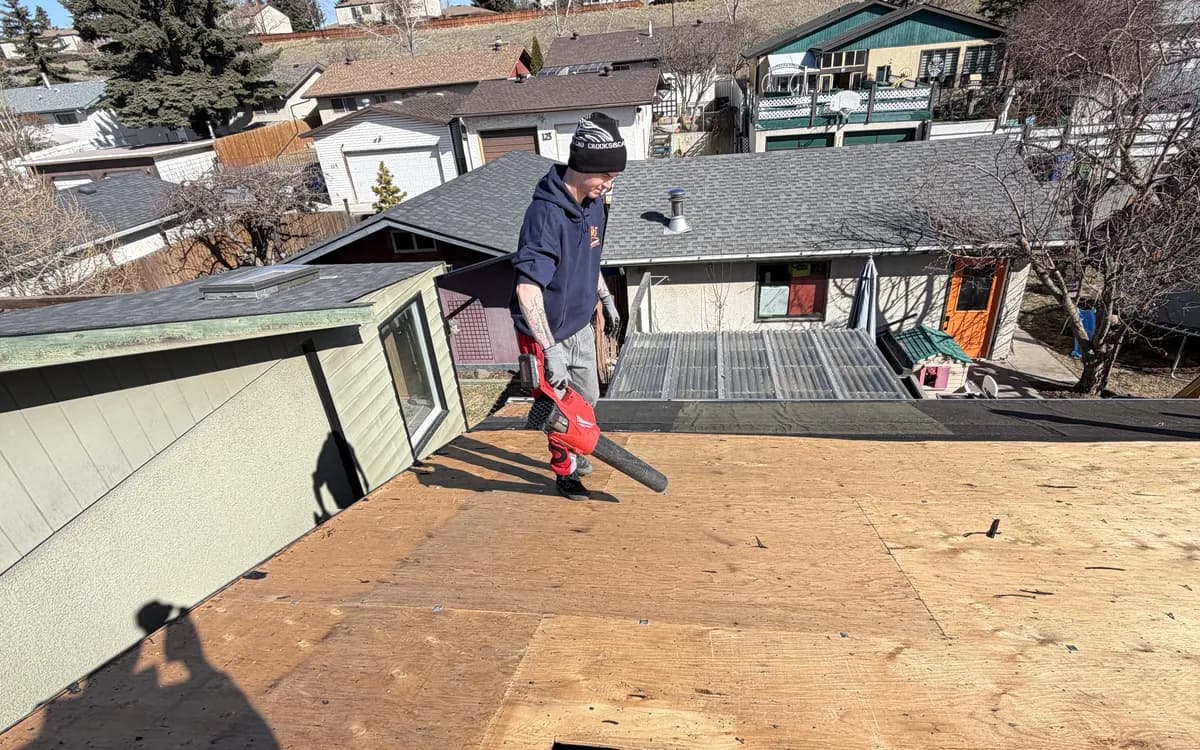 Roof decking exposed during a Calgary roof job, showing the plywood under the shingles